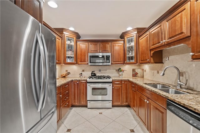 740 Turnpike St Unit 7, Beaver, PA 15009 - kitchen featuring appliances with stainless steel finishes, light tile patterned flooring, brown cabinets, decorative backsplash, and recessed lighting