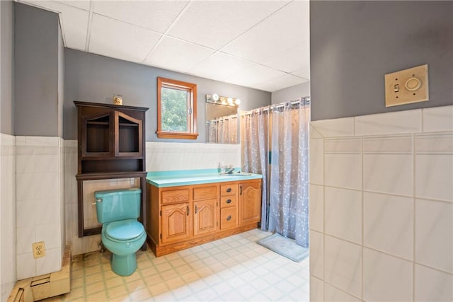 769 Russell Ave, Greater Johnstown School District, PA 15902 - bathroom with tile walls, a paneled ceiling, vanity, a wainscoted wall, and a shower with curtain