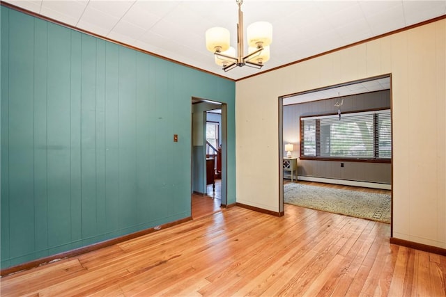 769 Russell Ave, Greater Johnstown School District, PA 15902 - unfurnished room featuring a baseboard radiator, a chandelier, ornamental molding, plenty of natural light, and light wood finished floors
