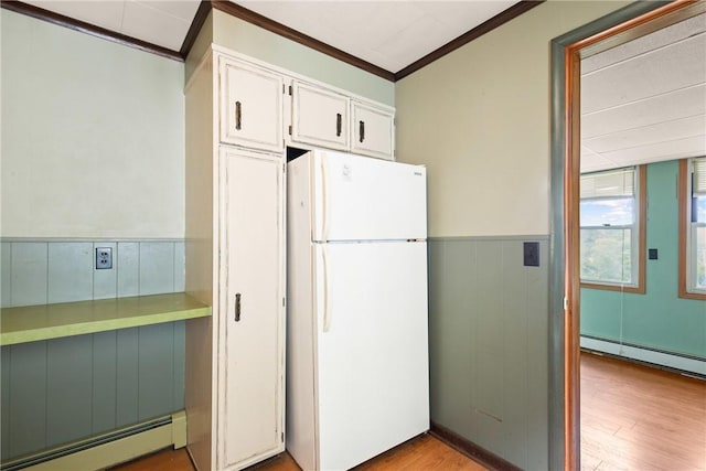 769 Russell Ave, Greater Johnstown School District, PA 15902 - kitchen with freestanding refrigerator, baseboard heating, crown molding, white cabinetry, and light wood-style flooring