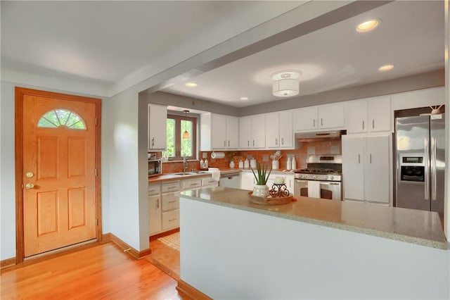 2116 Stewart Rd, South Park, PA 15129 - kitchen with appliances with stainless steel finishes, light wood-style flooring, white cabinetry, under cabinet range hood, and recessed lighting