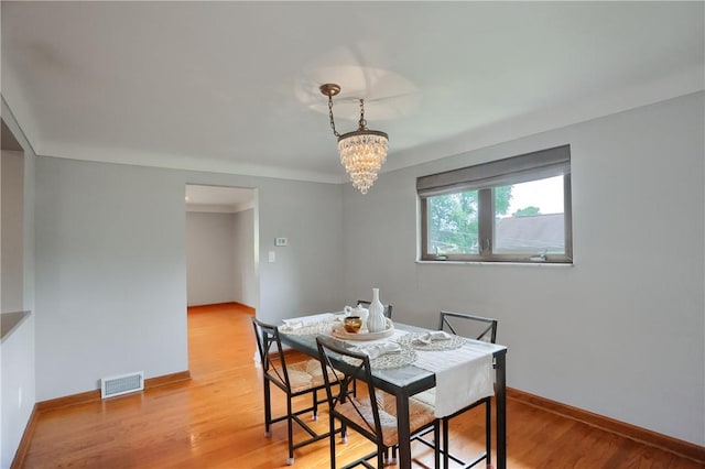 2116 Stewart Rd, South Park, PA 15129 - dining area with a chandelier and light wood-style floors