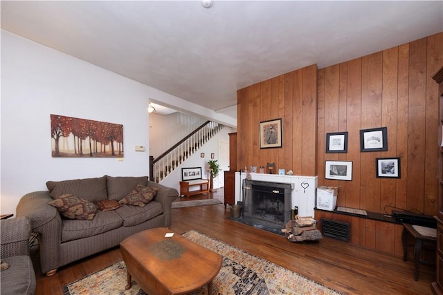 2507 Duncan Ave, Hampton, PA 15101 - living area featuring stairs, wood finished floors, wooden walls, and a fireplace