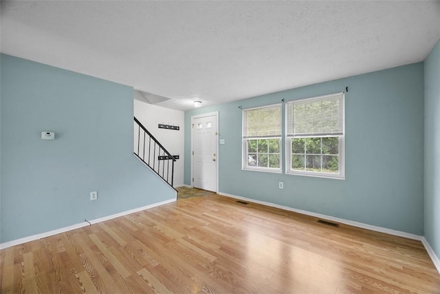 301 Laporte Ct, Cranberry Twp, PA 16066 - unfurnished living room featuring stairs and wood finished floors