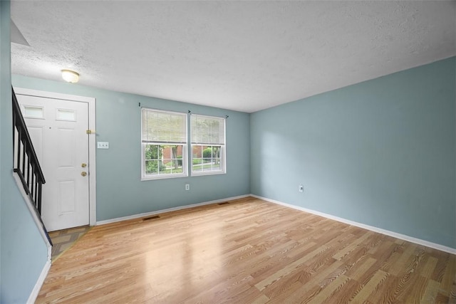 301 Laporte Ct, Cranberry Twp, PA 16066 - foyer entrance with light wood-style floors, a textured ceiling, and stairs