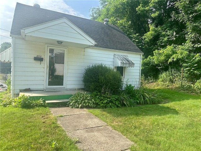 853 5th St, East Rochester, PA 15074 - view of front of home with a front yard and roof with shingles