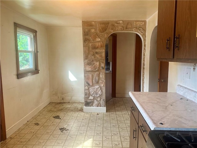 853 5th St, East Rochester, PA 15074 - kitchen with arched walkways, light flooring, and light countertops