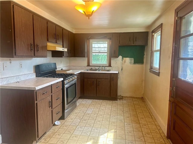 853 5th St, East Rochester, PA 15074 - kitchen with gas stove, under cabinet range hood, light countertops, and light flooring