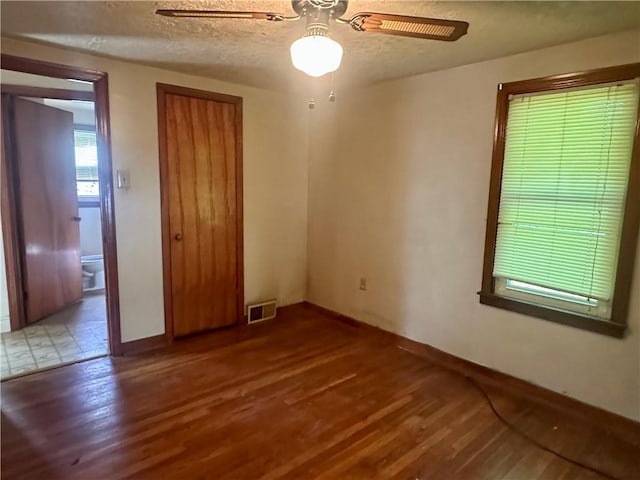 853 5th St, East Rochester, PA 15074 - spare room featuring wood finished floors, ceiling fan, and a textured ceiling