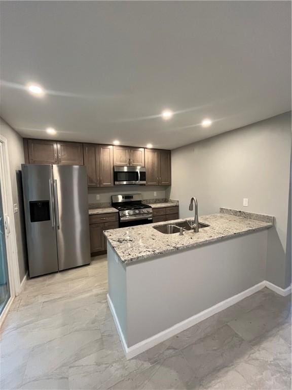 446 Enright Ct, East Liberty, PA 15206 - kitchen with appliances with stainless steel finishes, recessed lighting, a peninsula, light stone countertops, and dark brown cabinetry