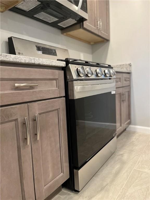 446 Enright Ct, East Liberty, PA 15206 - kitchen with stainless steel range with gas stovetop and light stone counters