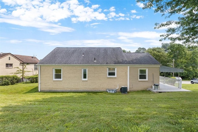3040 Broadway Ave, Castle Shannon, PA 15234 - rear view of property featuring brick siding, a shingled roof, a lawn, and a patio