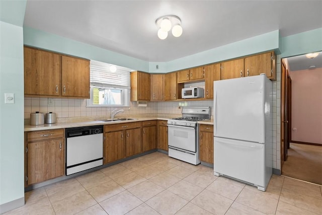 3040 Broadway Ave, Castle Shannon, PA 15234 - kitchen featuring white appliances, brown cabinets, light countertops, and backsplash