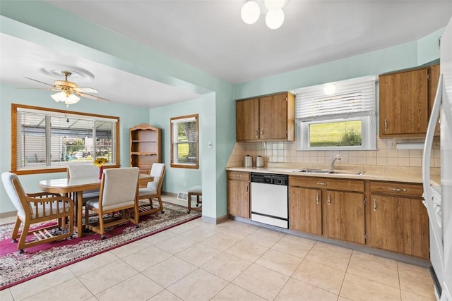 3040 Broadway Ave, Castle Shannon, PA 15234 - kitchen with white dishwasher, brown cabinets, and light countertops