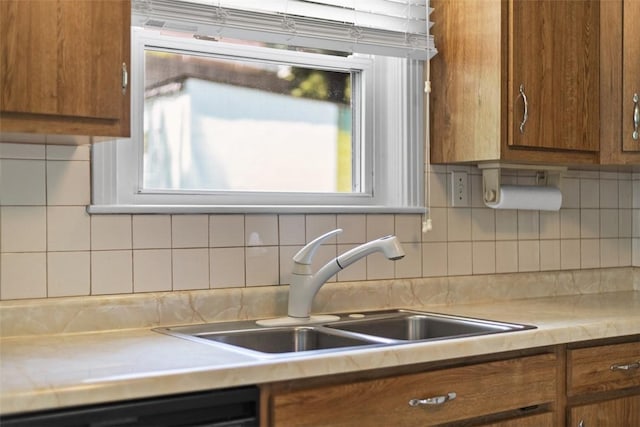 3040 Broadway Ave, Castle Shannon, PA 15234 - kitchen with brown cabinetry, light countertops, tasteful backsplash, and dishwasher