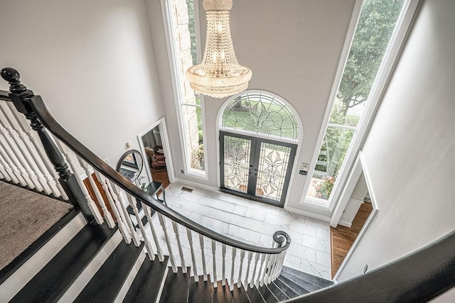 117 Cidar Ln, Peters Twp, PA 15317 - entryway featuring a towering ceiling, stairs, and wood finished floors