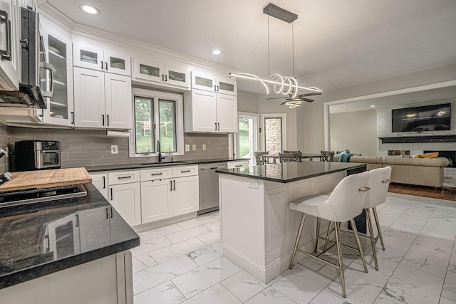 117 Cidar Ln, Peters Twp, PA 15317 - kitchen featuring light marble finish floors, stainless steel appliances, a kitchen island, recessed lighting, and a breakfast bar area
