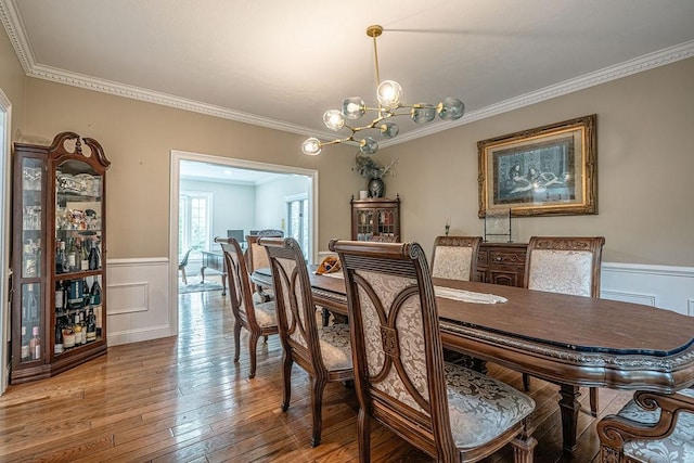 117 Cidar Ln, Peters Twp, PA 15317 - dining room featuring a chandelier, a wainscoted wall, crown molding, light wood finished floors, and a decorative wall