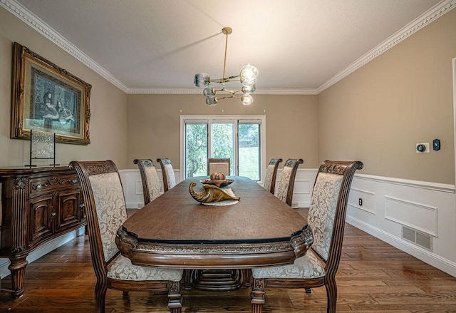 117 Cidar Ln, Peters Twp, PA 15317 - dining room with crown molding, wood finished floors, a wainscoted wall, a chandelier, and a decorative wall
