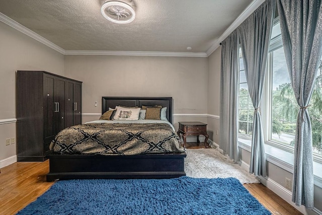 117 Cidar Ln, Peters Twp, PA 15317 - bedroom featuring light wood-type flooring, ornamental molding, and a textured ceiling