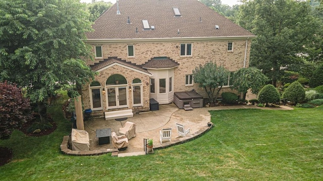 117 Cidar Ln, Peters Twp, PA 15317 - back of property featuring french doors, a hot tub, a patio, a lawn, and brick siding