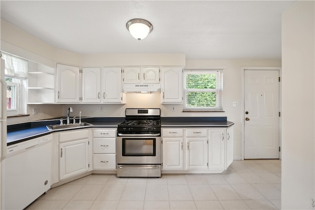 228 Mcmasters Dr, Monroeville, PA 15146 - kitchen featuring white dishwasher, stainless steel gas stove, dark countertops, under cabinet range hood, and white cabinets