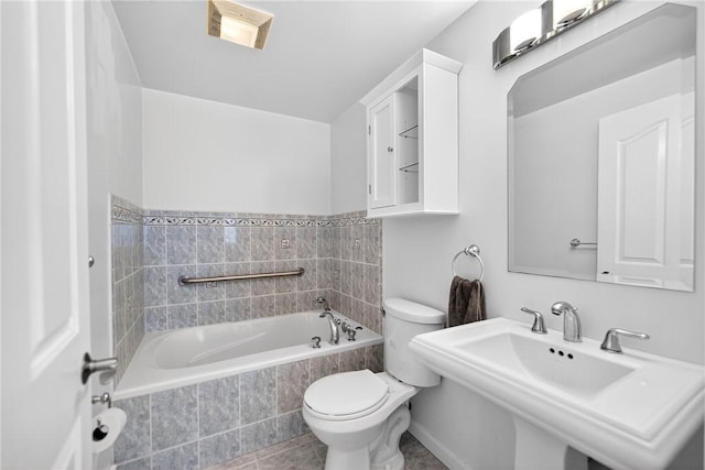 228 Mcmasters Dr, Monroeville, PA 15146 - bathroom featuring tiled tub and tile patterned flooring