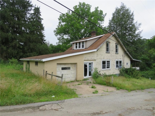 60 Wisetown Rd, Pa, PA 15022 - view of front of property featuring brick siding, a chimney, driveway, and a garage