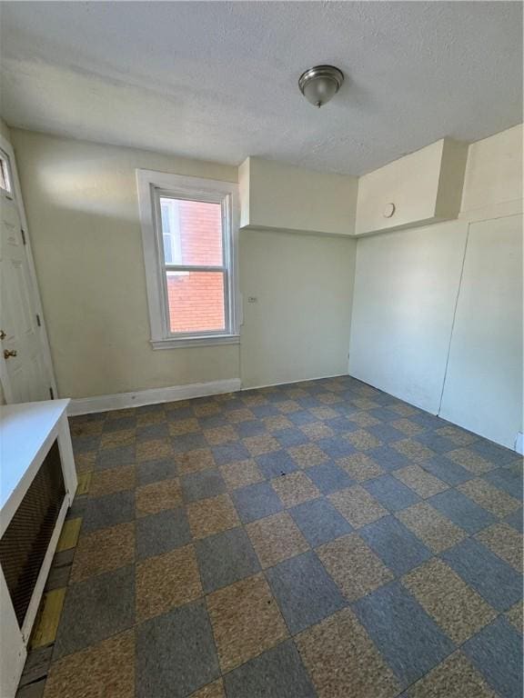 207 N Sprague Ave, Bellevue, PA 15202 - unfurnished room featuring a textured ceiling and baseboards