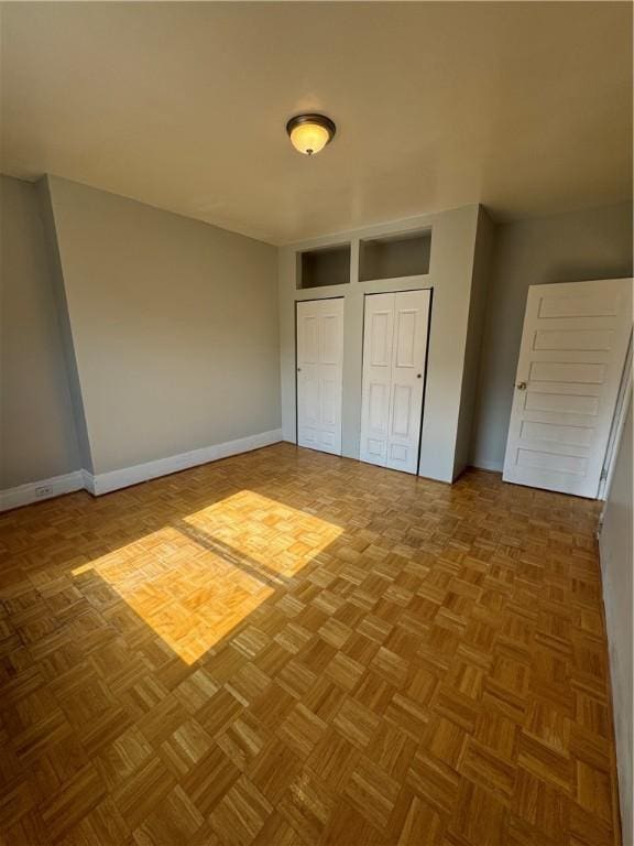 207 N Sprague Ave, Bellevue, PA 15202 - unfurnished bedroom with two closets and baseboards