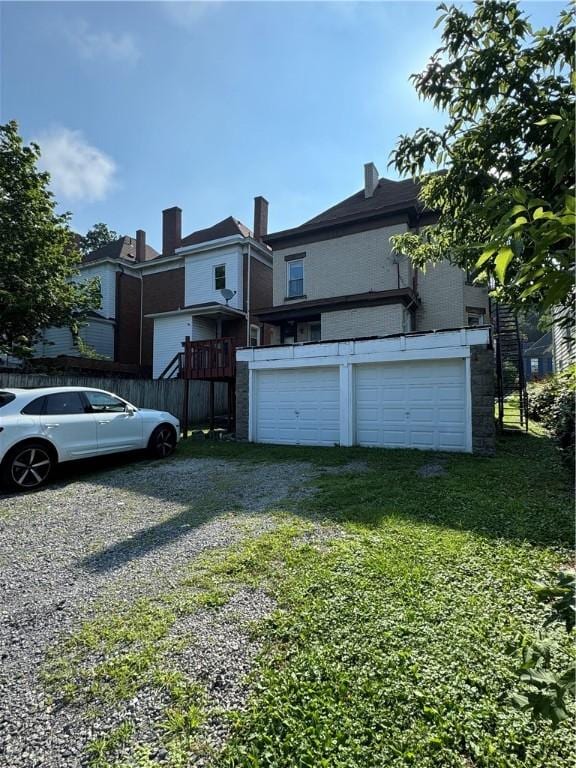 207 N Sprague Ave, Bellevue, PA 15202 - view of side of property featuring driveway, an attached garage, and a yard