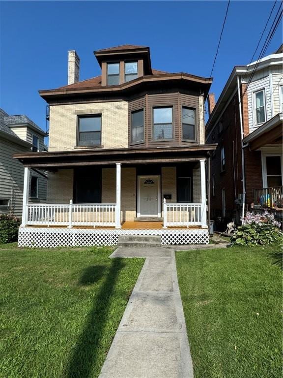 207 N Sprague Ave, Bellevue, PA 15202 - view of front of home with a porch, a front lawn, and a chimney