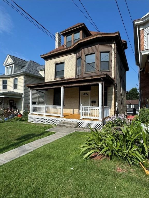 207 N Sprague Ave, Bellevue, PA 15202 - view of front facade with a porch, a front lawn, brick siding, and a chimney