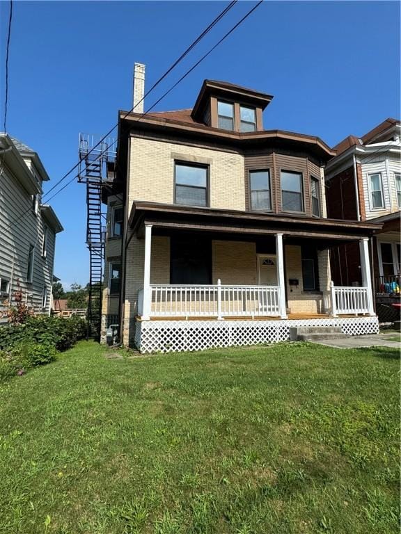 207 N Sprague Ave, Bellevue, PA 15202 - view of front of home featuring a front yard, a chimney, and a porch