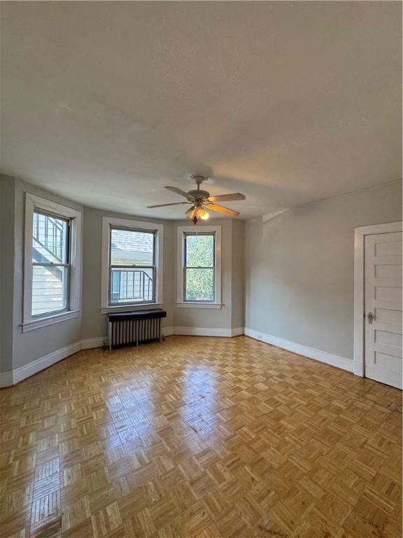 207 N Sprague Ave, Bellevue, PA 15202 - unfurnished living room featuring radiator and a ceiling fan