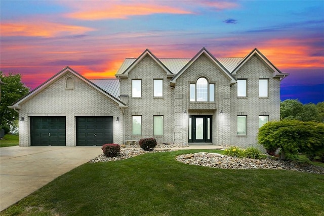 1007 Cicero Dr, Hempfield Twp, PA 15642 - traditional home with a lawn, driveway, an attached garage, and brick siding
