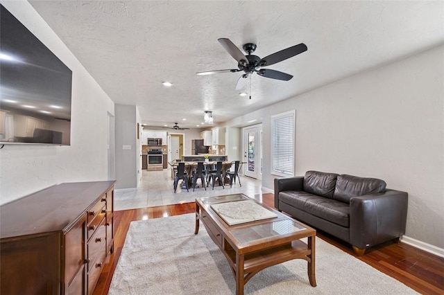 1007 Cicero Dr, Hempfield Twp, PA 15642 - living area featuring a ceiling fan, wood finished floors, and a textured ceiling