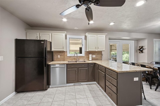 1007 Cicero Dr, Hempfield Twp, PA 15642 - kitchen featuring freestanding refrigerator, dishwasher, a peninsula, ceiling fan, and backsplash