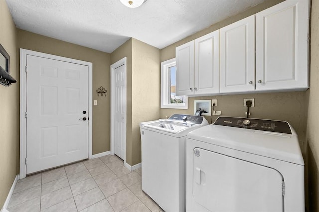1007 Cicero Dr, Hempfield Twp, PA 15642 - laundry area with cabinet space, washing machine and clothes dryer, light tile patterned floors, and a textured ceiling
