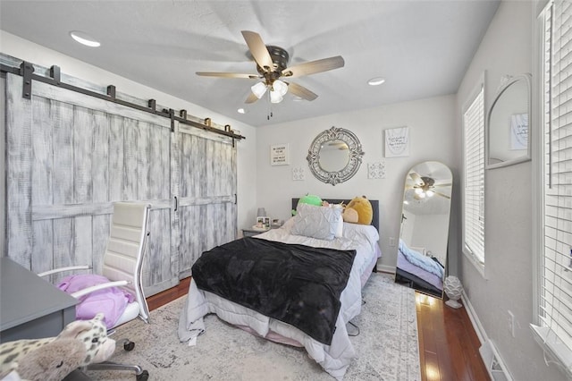 1007 Cicero Dr, Hempfield Twp, PA 15642 - bedroom featuring a barn door, wood finished floors, recessed lighting, and ceiling fan