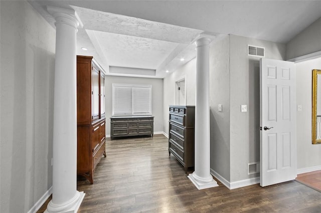 1007 Cicero Dr, Hempfield Twp, PA 15642 - hall with ornate columns, dark wood-style flooring, and a raised ceiling