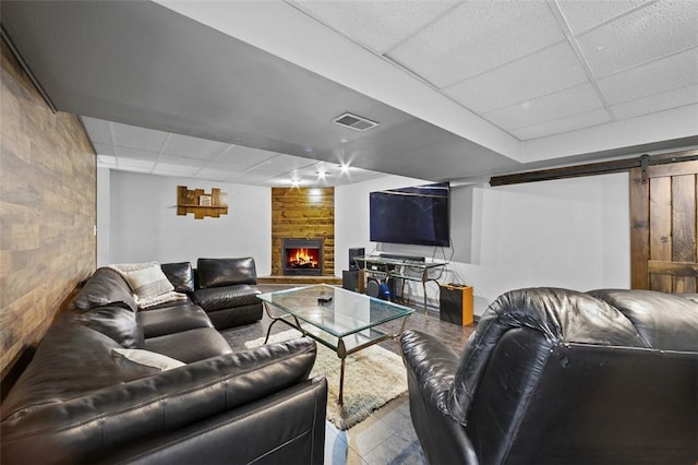 1007 Cicero Dr, Hempfield Twp, PA 15642 - living area featuring a drop ceiling, a fireplace, and a barn door
