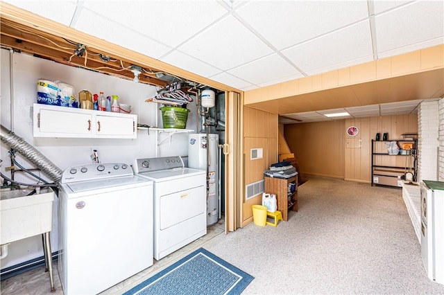 209 Farmbrook Dr, Hempfield Twp, PA 15601 - laundry area with water heater, cabinet space, washing machine and clothes dryer, and wood walls
