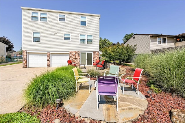 209 Farmbrook Dr, Hempfield Twp, PA 15601 - view of patio with driveway and an attached garage