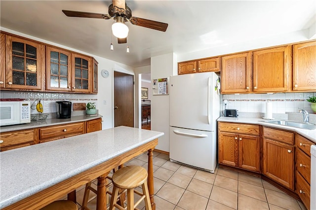 209 Farmbrook Dr, Hempfield Twp, PA 15601 - kitchen featuring white appliances, backsplash, a kitchen breakfast bar, and glass insert cabinets