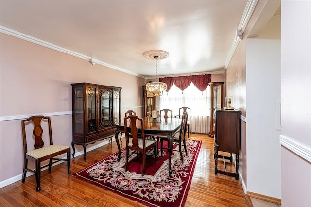209 Farmbrook Dr, Hempfield Twp, PA 15601 - dining space featuring ornamental molding, wood finished floors, and a chandelier