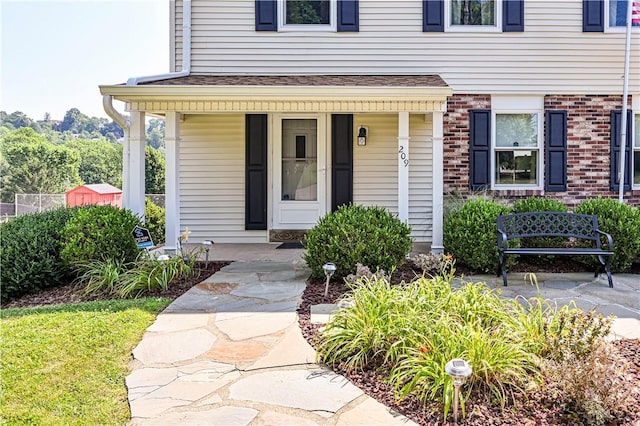 209 Farmbrook Dr, Hempfield Twp, PA 15601 - view of exterior entry with covered porch and brick siding