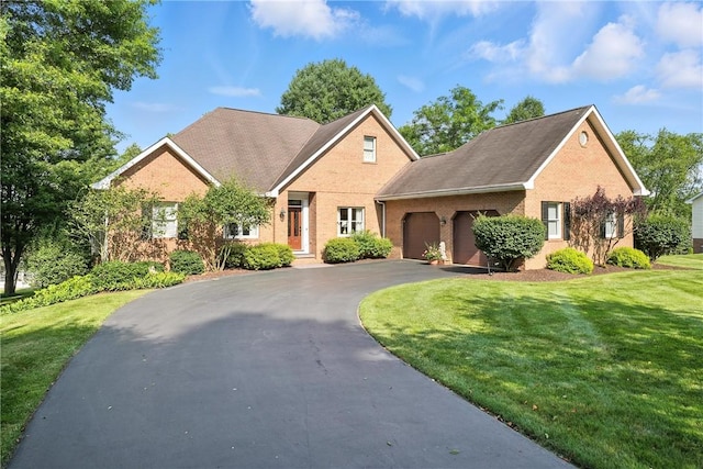 13 Kings Ln, Pine Twp, PA 16127 - traditional-style house with an attached garage, brick siding, asphalt driveway, and a front yard
