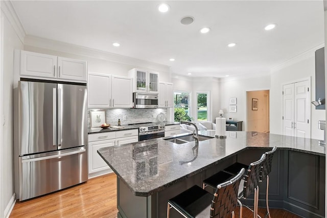 13 Kings Ln, Pine Twp, PA 16127 - kitchen featuring stainless steel appliances, ornamental molding, white cabinets, light wood-style floors, and a breakfast bar area