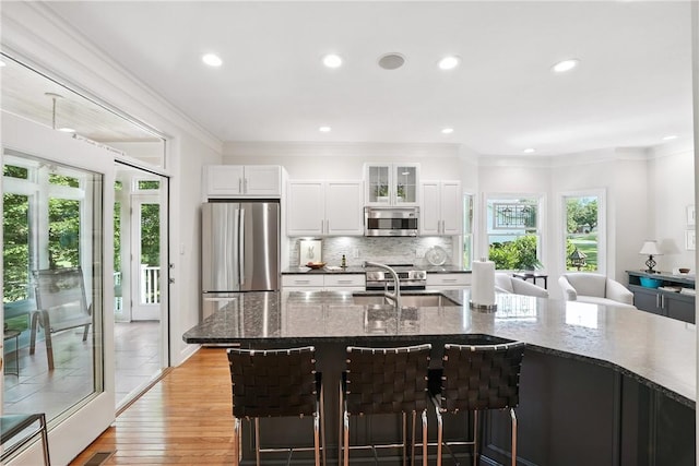 13 Kings Ln, Pine Twp, PA 16127 - kitchen featuring appliances with stainless steel finishes, ornamental molding, recessed lighting, decorative backsplash, and a breakfast bar area